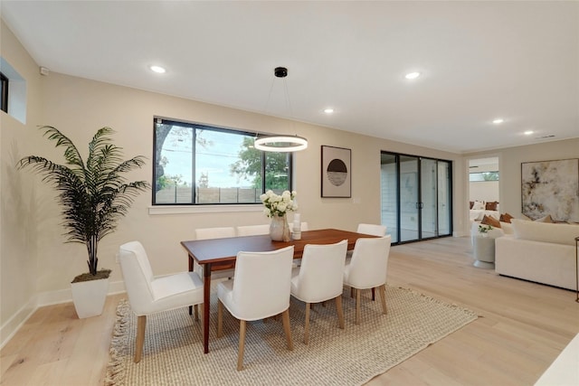 dining space with light hardwood / wood-style floors