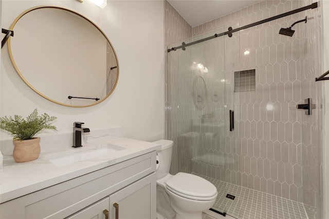 bathroom with vanity, a shower with shower door, and toilet