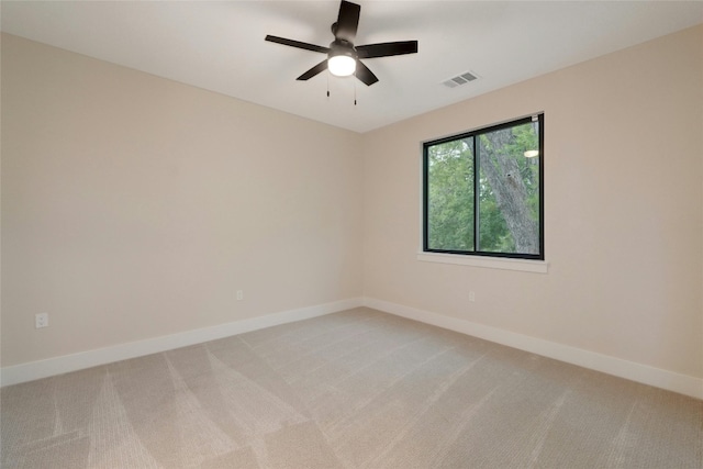 unfurnished room featuring ceiling fan and carpet