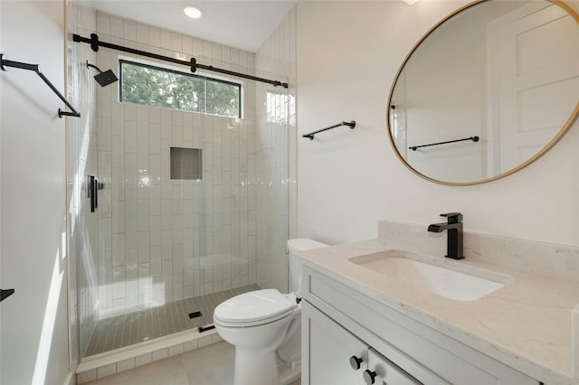 bathroom featuring tile patterned floors, vanity, toilet, and a shower with shower door