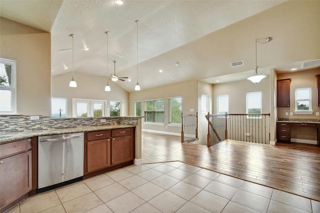 kitchen featuring dishwasher, pendant lighting, light tile patterned flooring, and backsplash