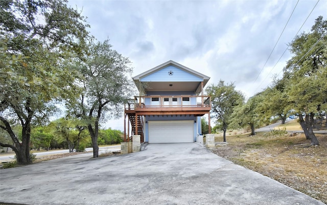 view of front facade with a garage and a deck