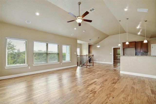 unfurnished living room with ceiling fan, lofted ceiling, and light hardwood / wood-style flooring