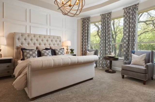 bedroom featuring carpet flooring, crown molding, and a notable chandelier