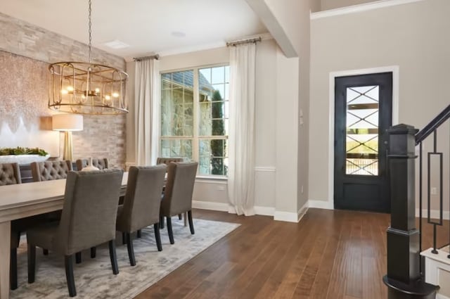 dining space featuring dark wood-type flooring and a notable chandelier