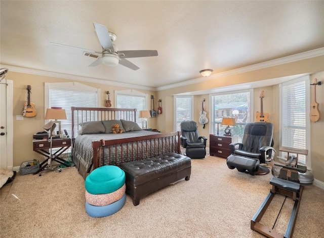 carpeted bedroom with ceiling fan and ornamental molding