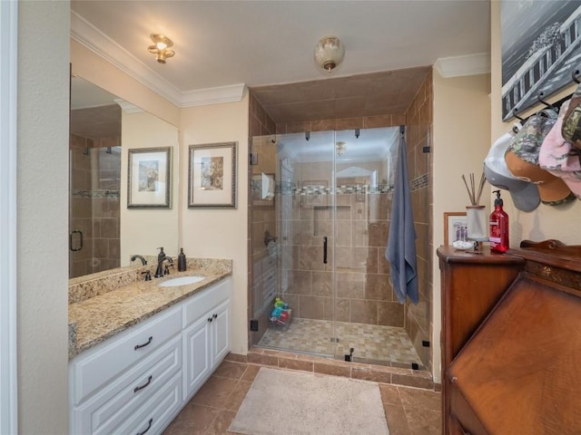 bathroom with tile patterned flooring, vanity, crown molding, and walk in shower