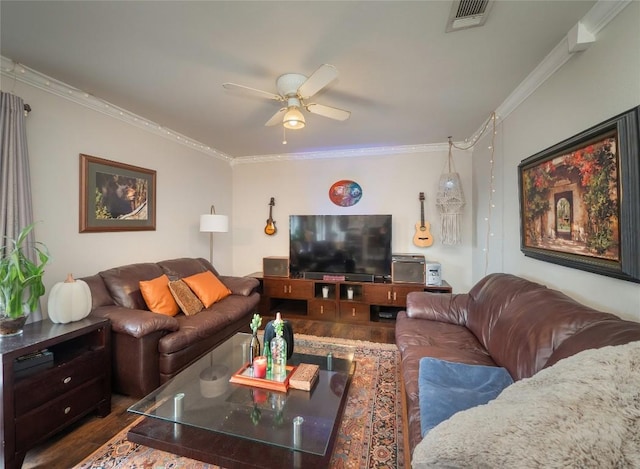 living room featuring dark wood-type flooring, ceiling fan, and ornamental molding