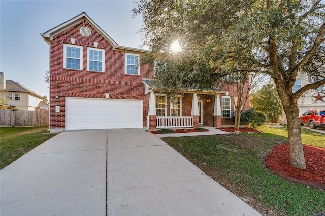 view of front of property featuring covered porch, a garage, and a front lawn