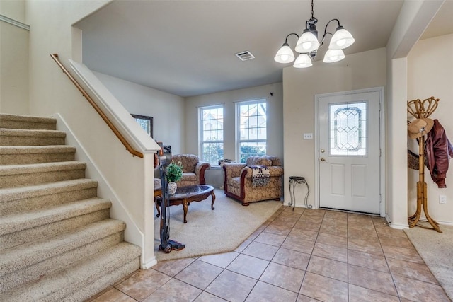 tiled foyer featuring a chandelier