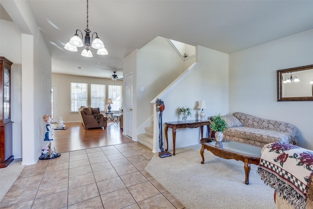 interior space with light tile patterned floors and ceiling fan with notable chandelier