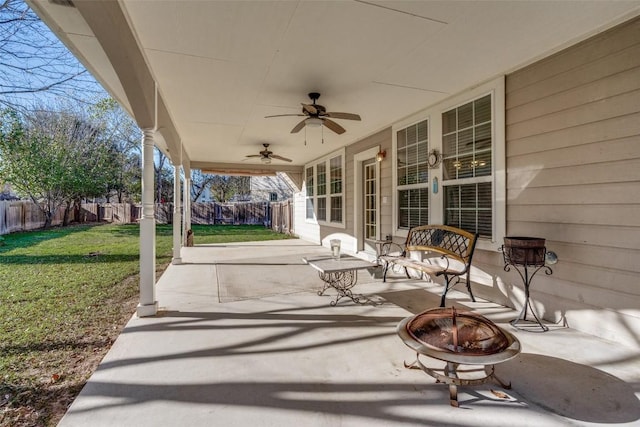 view of patio / terrace with ceiling fan and a fire pit