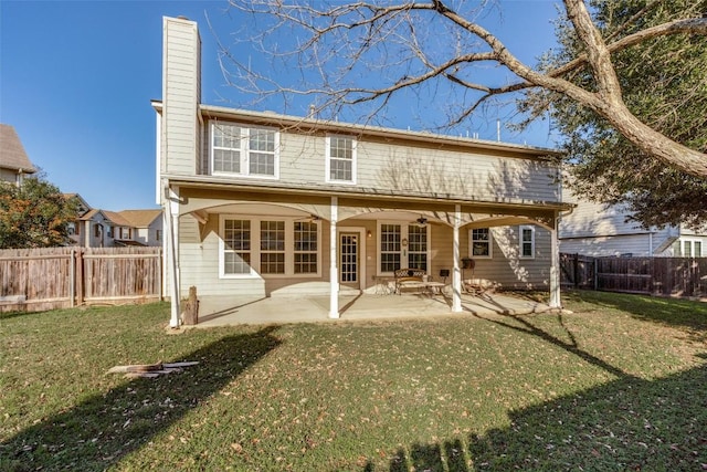 rear view of house with a yard and a patio