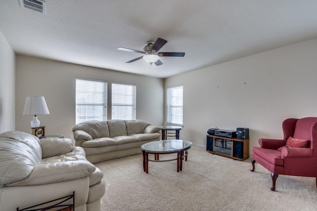 living room featuring ceiling fan and light carpet