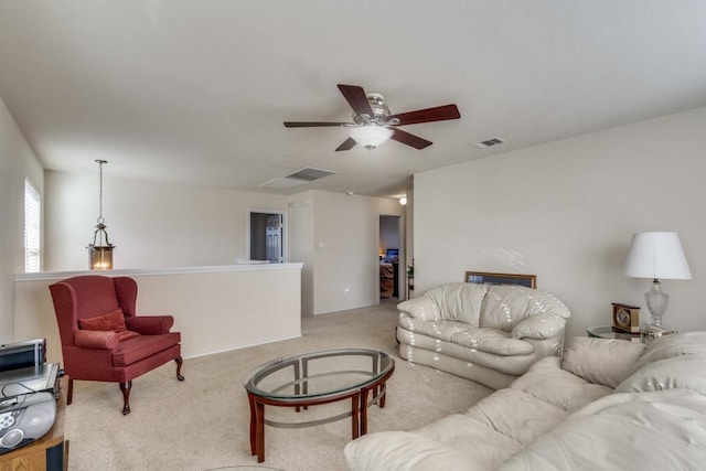 carpeted living room with ceiling fan