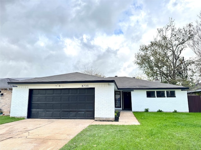 ranch-style house with a garage and a front lawn