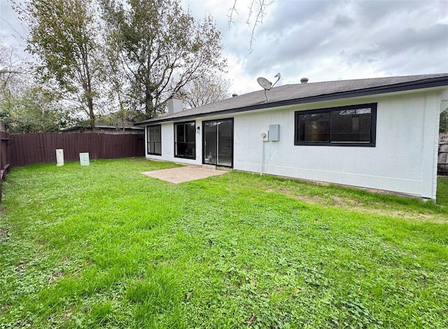 rear view of property with a lawn