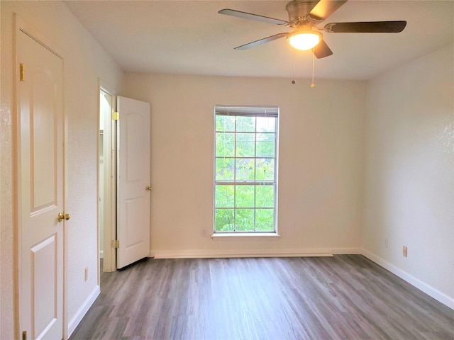 empty room with hardwood / wood-style flooring and ceiling fan