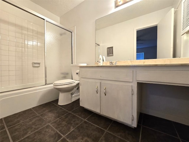 full bathroom with enclosed tub / shower combo, tile patterned floors, a textured ceiling, and vanity