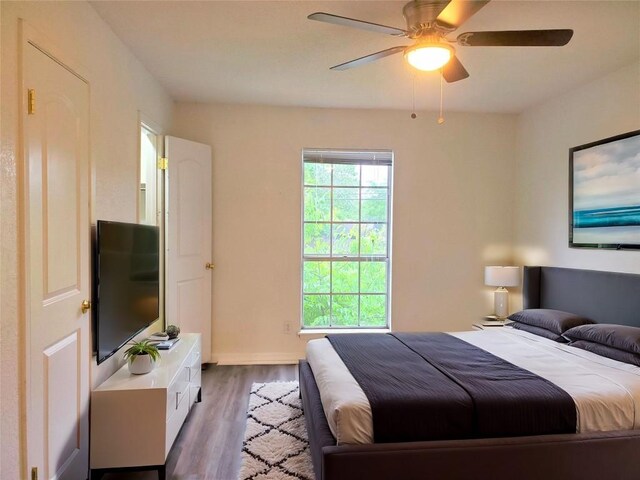 bedroom featuring ceiling fan and dark hardwood / wood-style floors