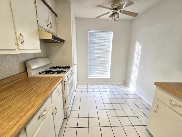 kitchen with white cabinetry, light tile patterned floors, ceiling fan, gas range gas stove, and a textured ceiling