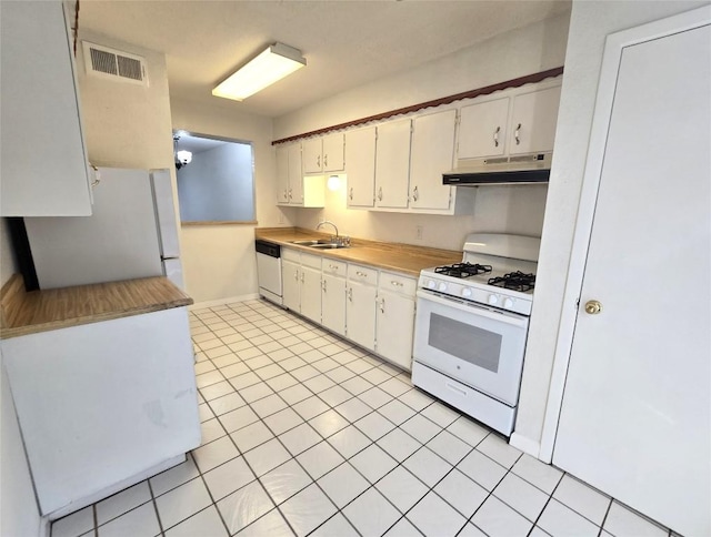 kitchen featuring white cabinetry, sink, and white appliances