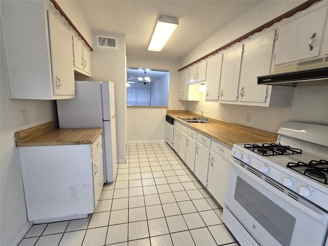 kitchen with white cabinetry, sink, stainless steel appliances, and light tile patterned flooring