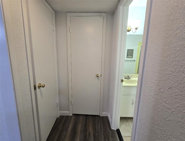 hall featuring dark hardwood / wood-style flooring and sink