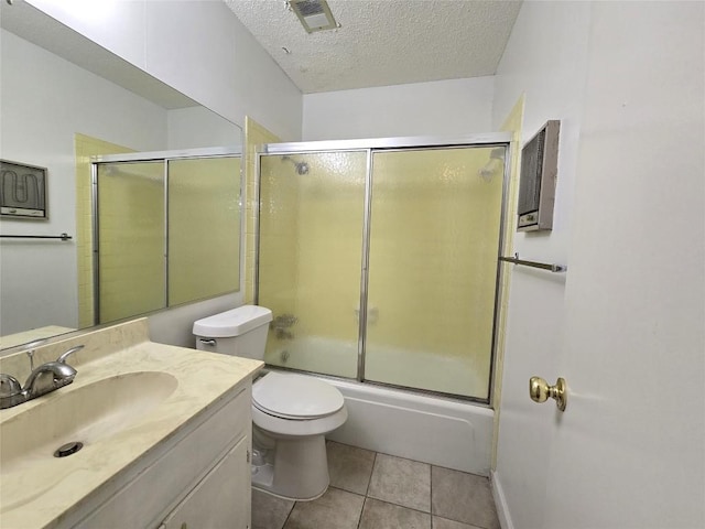 full bathroom featuring toilet, a textured ceiling, vanity, enclosed tub / shower combo, and tile patterned flooring