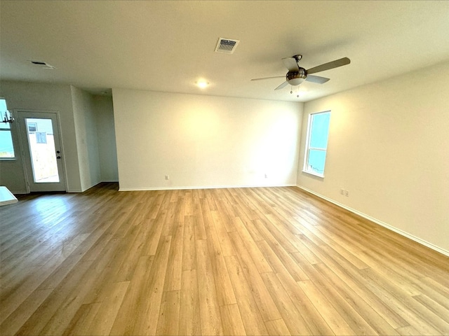 unfurnished room with ceiling fan and light wood-type flooring