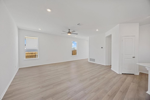 spare room featuring light wood finished floors, a ceiling fan, visible vents, and recessed lighting