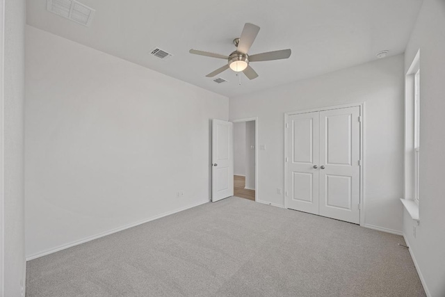 unfurnished bedroom with a closet, visible vents, baseboards, and carpet flooring