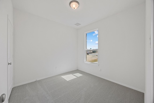 carpeted spare room featuring visible vents and baseboards