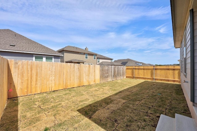 view of yard with a fenced backyard