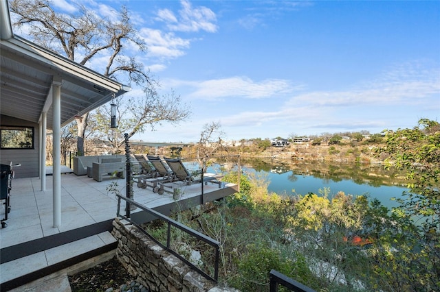 exterior space with a patio area and a water view