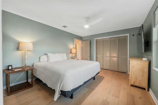 bedroom featuring ceiling fan, light hardwood / wood-style floors, and a closet