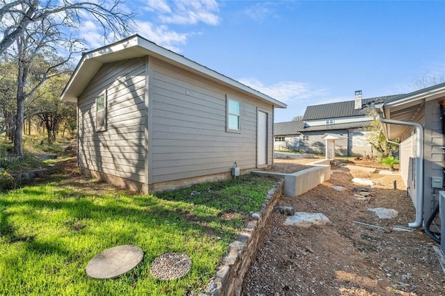 view of side of home with a yard