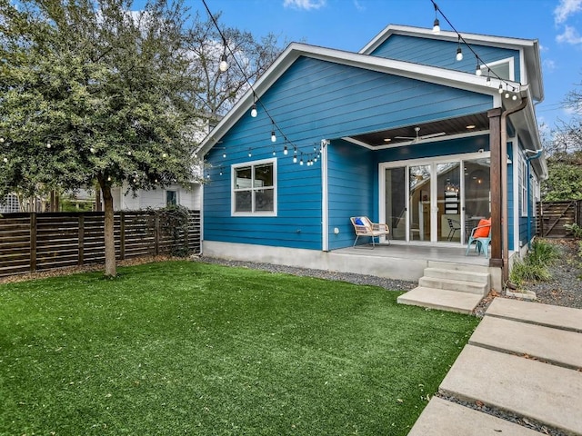 back of house featuring a yard