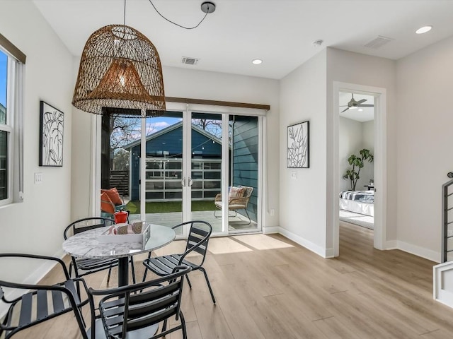 dining area featuring light wood-type flooring and ceiling fan