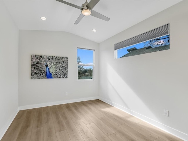 unfurnished room featuring ceiling fan, light hardwood / wood-style floors, and vaulted ceiling