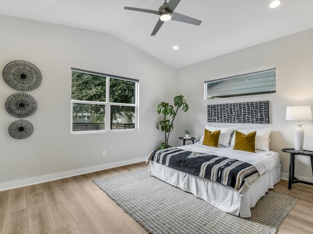 bedroom with light wood-type flooring, ceiling fan, and lofted ceiling