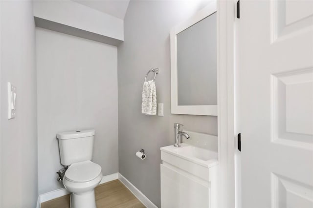 bathroom featuring hardwood / wood-style floors, vanity, and toilet