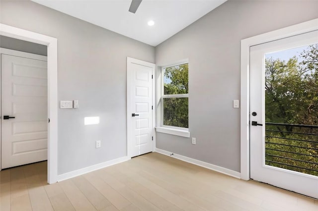 doorway to outside with ceiling fan and light wood-type flooring