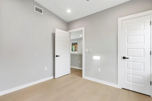 spare room featuring light hardwood / wood-style floors