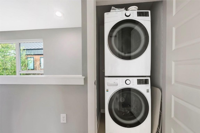 laundry room featuring stacked washer and clothes dryer