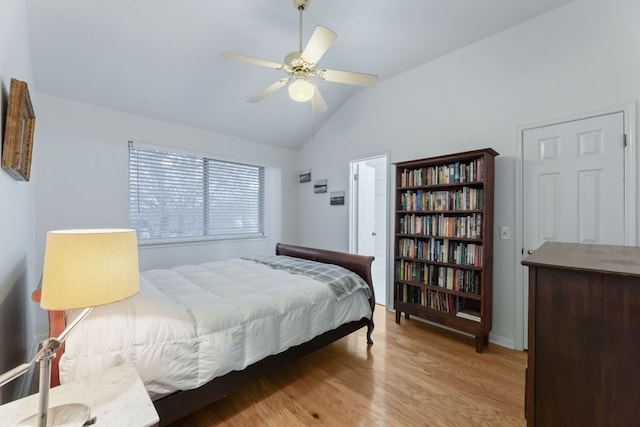 bedroom featuring ceiling fan, light hardwood / wood-style floors, and vaulted ceiling