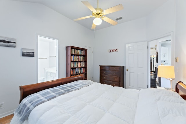 bedroom featuring ensuite bath, ceiling fan, hardwood / wood-style floors, and lofted ceiling