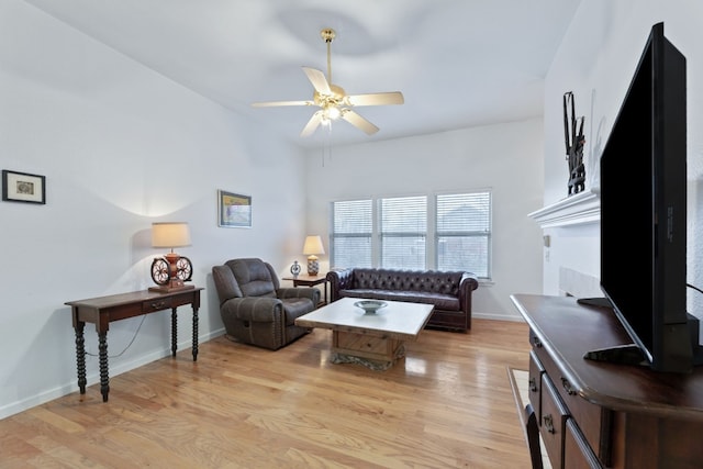 living room with ceiling fan and light wood-type flooring