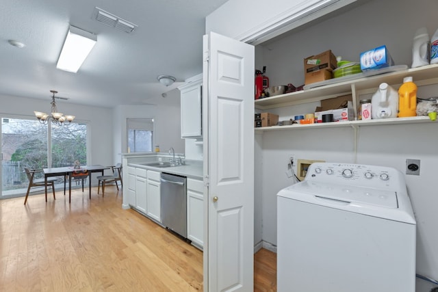 laundry area with washer / clothes dryer, sink, a chandelier, and light hardwood / wood-style flooring