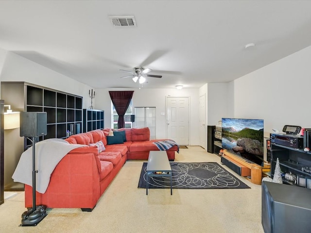 living room featuring ceiling fan and light colored carpet